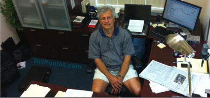 Bill Poulos at home sitting inside his Trading Lab